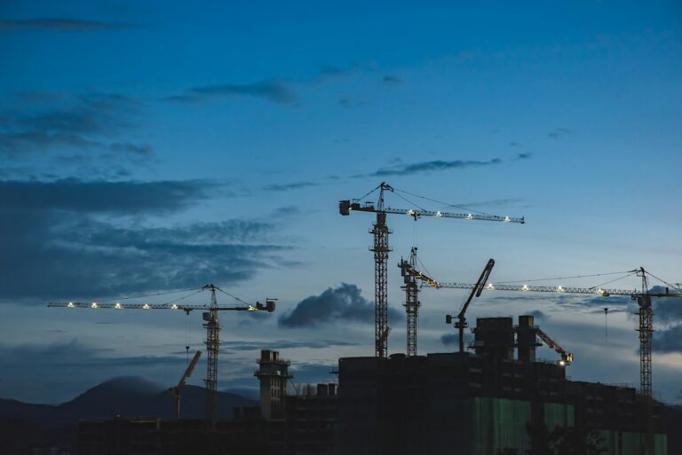 Post-construction cleaning and several cranes above the buildings